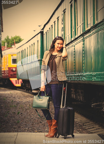 Image of beautiful middle-aged woman with luggage