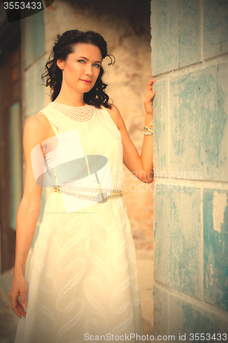 Image of beautiful middle-aged woman in a white summer  dress