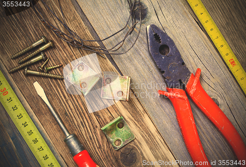 Image of Vintage pliers, screwdriver, screws, wire, angles and roulette