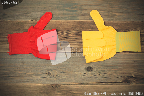 Image of two gloves with raised thumb up