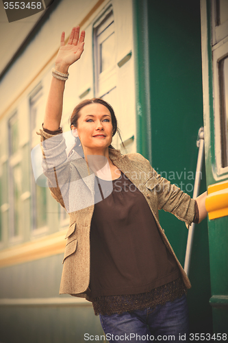 Image of beautiful middle-aged woman returned from a retro travel