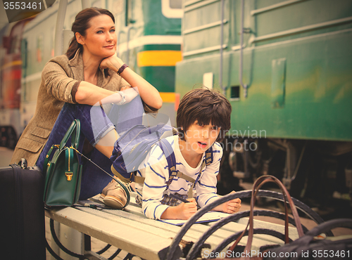 Image of Mother and son waiting for a train