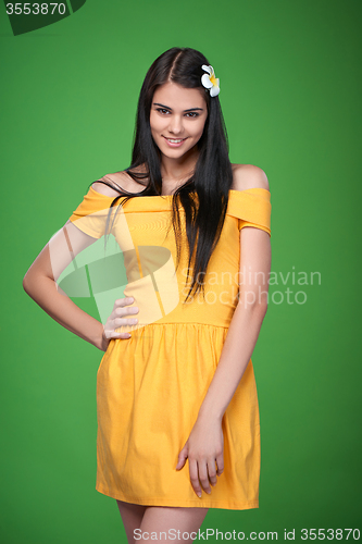 Image of Lovely girl in yellow strapless dress feeling shy