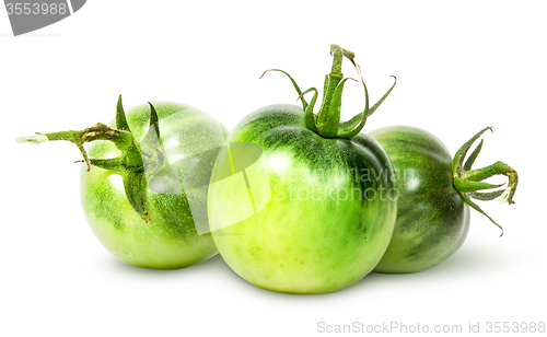 Image of In front three green tomatoes near