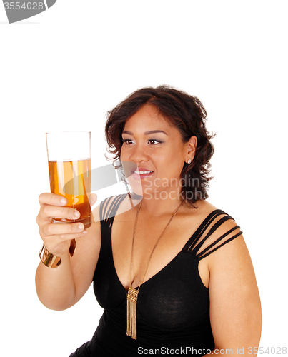 Image of Pretty girl holding up glass of tee.