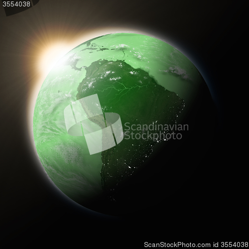 Image of Sun over South America on green planet Earth