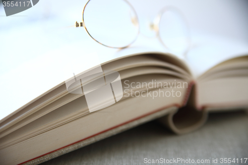 Image of glasses on top of book