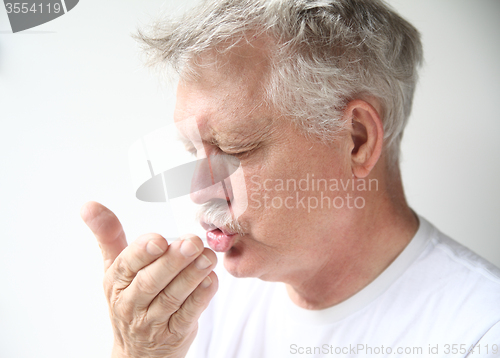 Image of Man sneezes 