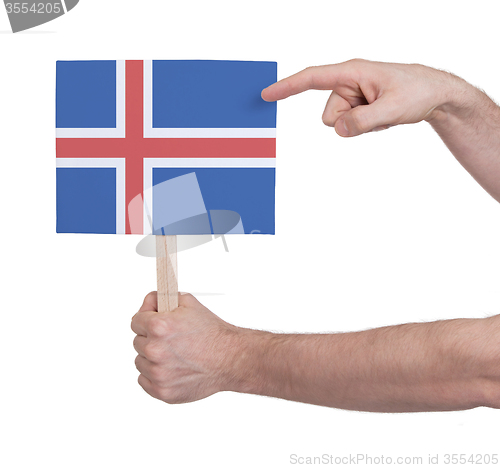 Image of Hand holding small card - Flag of Iceland