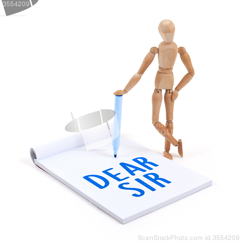 Image of Wooden mannequin writing - Dear sir