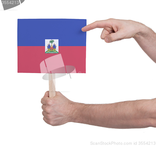 Image of Hand holding small card - Flag of Haiti