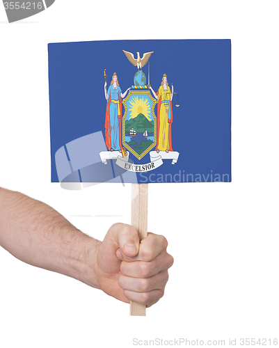 Image of Hand holding small card - Flag of New York