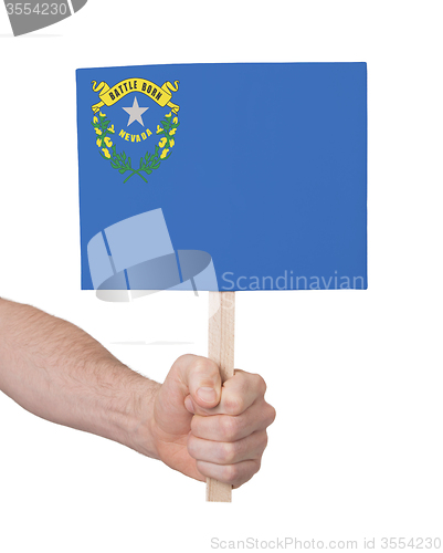 Image of Hand holding small card - Flag of Nevada