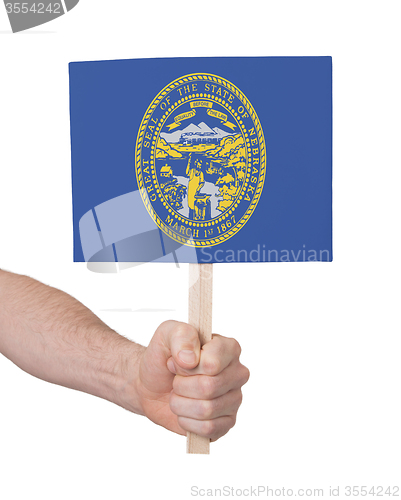 Image of Hand holding small card - Flag of Nebraska