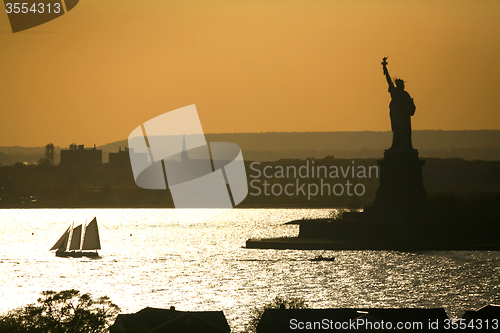 Image of Boat sailing next to Liberty Statue