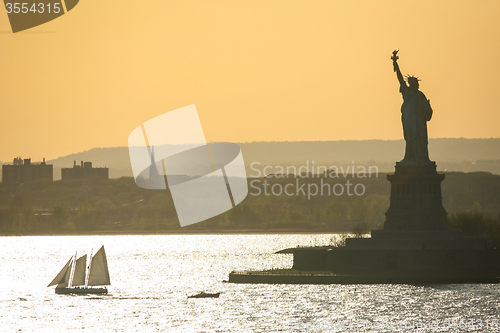 Image of Sailboat next to Liberty Statue