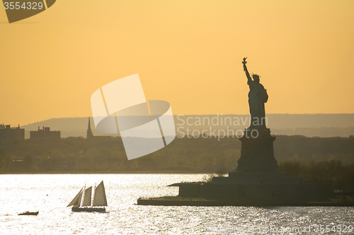Image of Sailboat next to Statue of Liberty