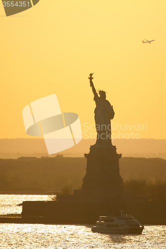 Image of Boat next to Statue of Liberty