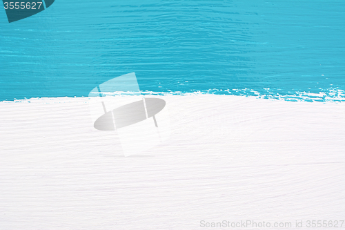 Image of Stripe of teal paint over white wooden background