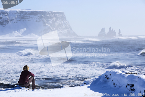 Image of Woman enjoys view o three pinnacles of Vik, Iceland