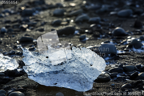 Image of Ice block on black sand beach at glacier lagoon Jokulsarlon, Ice