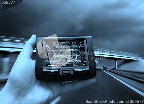 Image of GPS Vehicle navigation system in a man hand.