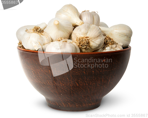 Image of In front whole head of garlic in ceramic bowl