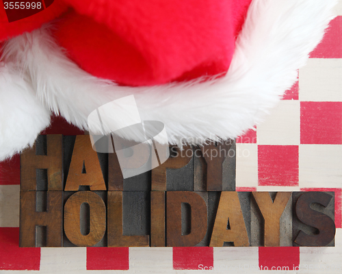 Image of Santa Claus hat with happy holidays words