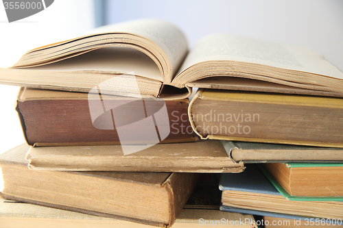 Image of open book on top of stacks