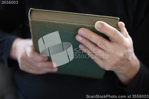 Image of hands holding a book 