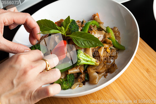 Image of Food Stylist Garnishing a Dish