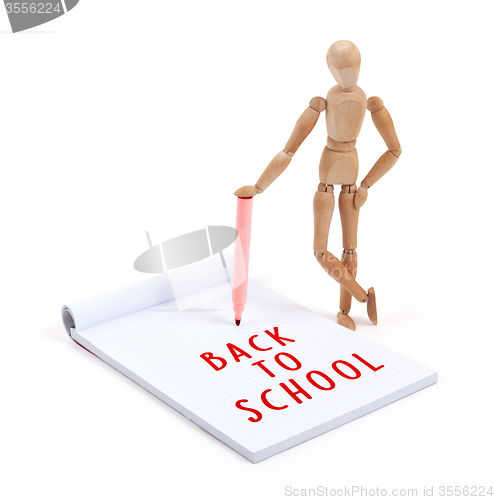 Image of Wooden mannequin writing - Back to school