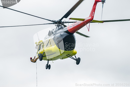 Image of Rescuer is landed from MI-8 helicopter by rope