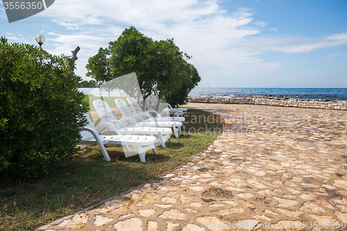 Image of loungers on the rocky beach