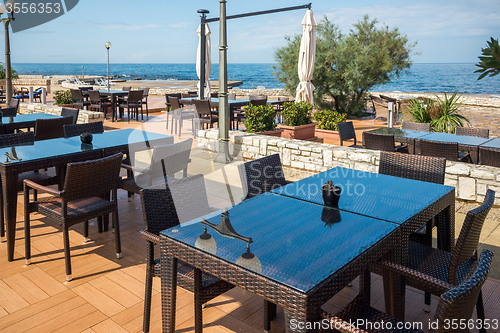 Image of modern wicker furniture in street restaurant 