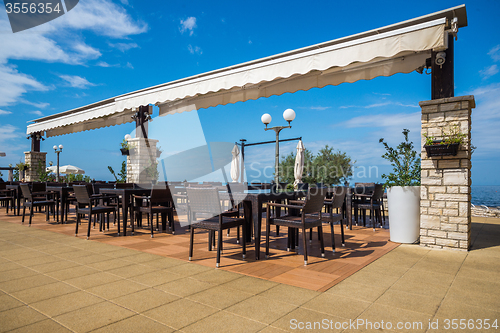 Image of modern wicker furniture in street restaurant 