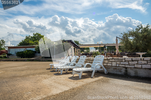 Image of loungers on the rocky beach