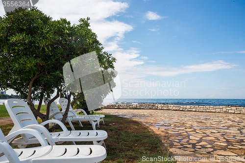 Image of loungers on the rocky beach