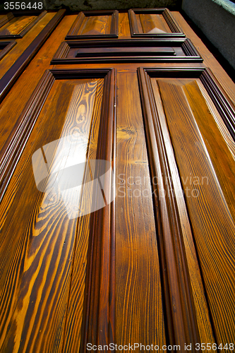 Image of abstract cross   brass brown   closed wood  sumirago sunny day