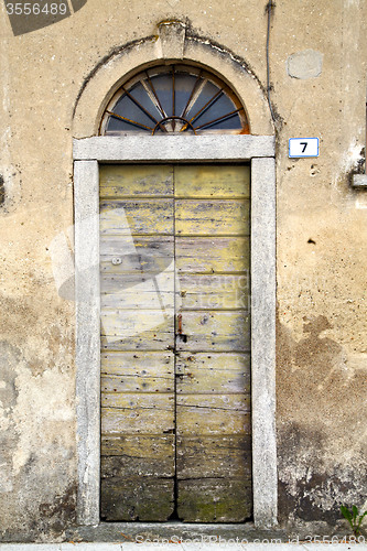 Image of abstract cross    closed wood door    italy azzate