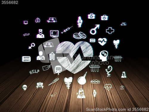 Image of Medicine concept: Heart in grunge dark room