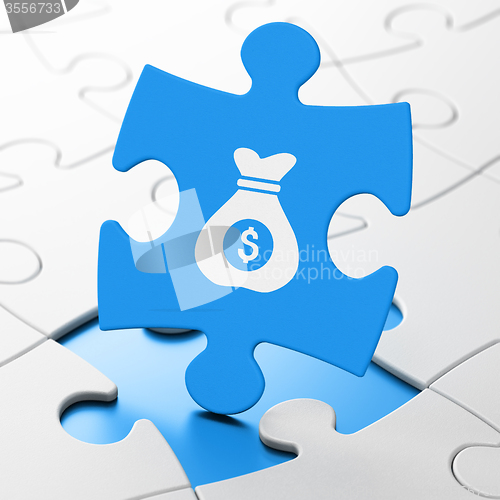 Image of Business concept: Money Bag on puzzle background