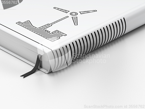 Image of Manufacuring concept: closed book, Windmill on white background