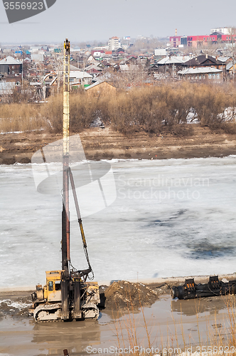 Image of Pile driving machine in construction site. Tyumen