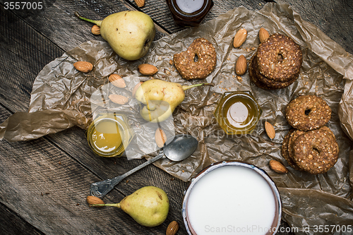 Image of Almonds pears Cookies and joghrut on wood boards