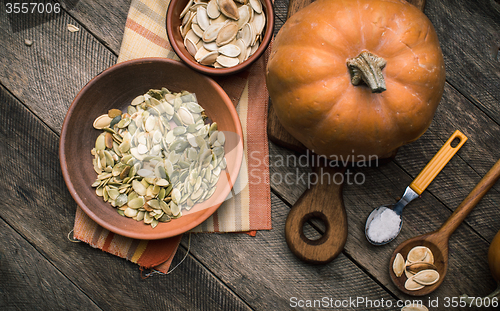 Image of Rustic style pumpkins with seeds on wood