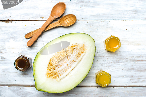 Image of Healthy melon with honey on white board