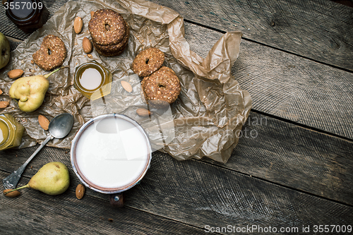 Image of Tasty Pears almonds Cookies and joghurt on rustic wood