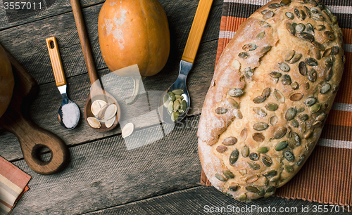 Image of Rustic style pumpkins and bakery with seeds on cloth