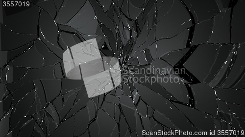 Image of Pieces of cracked glass on black background